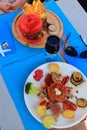 Plate of red tuna with its vegetable garnish and red hamburger in a restaurant