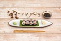 Plate of red tuna maki with white rice with Japanese vinegar with star anise, pumpkin seeds, chopsticks and soy sauce Royalty Free Stock Photo