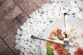 A plate with remains of food and inverted glass on a white stones background. Cutlery. Copy space. Royalty Free Stock Photo