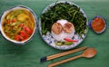 Vegetarian meal, rice dish with boiled water morning glory, vegan sausage, sour soup bowl Royalty Free Stock Photo