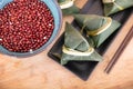 A plate of rice dumplings and a bowl of red beans on a cutting board Royalty Free Stock Photo