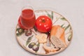 Plate with a ripe, local, freshly picked, beef steak tomatoes with a chuck of aged cheese, a section of freshly baked baguette Royalty Free Stock Photo