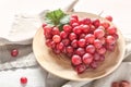 Plate with ripe tasty grapes on table