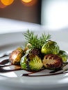 A plate of roasted Brussels sprouts drizzled with balsamic glaze and garnished with herbs Royalty Free Stock Photo