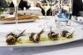 Plate with rolled and au gratin anchovy fillets with sliced and marinated onions in a restaurant