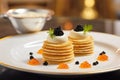 plate of russian blini with caviar and sour cream