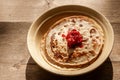 Plate with Russian pancakes and cranberry jam Royalty Free Stock Photo