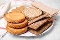Plate of rye crispbreads, rice cakes and rusks on white checkered table Royalty Free Stock Photo