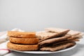 Plate of rye crispbreads, rice cakes and rusks on white table, space for text Royalty Free Stock Photo