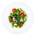 Plate with salad of fresh vegetables with avocado, isolated on white background Royalty Free Stock Photo