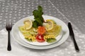 A plate of salad made of lettuce, tomato, corn, carrot, lemon and dill. Royalty Free Stock Photo