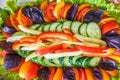 Plate of salad slices of cucumber tomatoes sweet pepper lettuce and basil