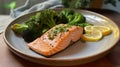 a plate of salmon with broccoli and lemon on it Royalty Free Stock Photo
