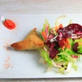 Plate of samoussa and lettuce salad