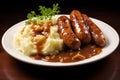 A plate of sausage and mashed potatoes, with cabbage and onion gravy