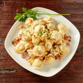 Plate of savory pelmeni dumplings on rustic wood