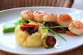 Plate of scallops cooked with its vegetables garnish in a french restaurant