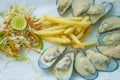 Plate with seafood fried potatoes and salad Royalty Free Stock Photo