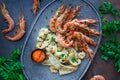 Plate with seafood, King prawns and squid, Fish menu in the restaurant, Dark background Royalty Free Stock Photo