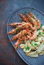 Plate with seafood, King prawns and squid, Fish menu in the restaurant, Dark background Royalty Free Stock Photo