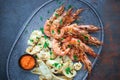 Plate with seafood, King prawns and squid, Fish menu in the restaurant, Dark background Royalty Free Stock Photo