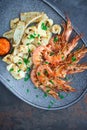 Plate with seafood, King prawns and squid, Fish menu in the restaurant, Dark background Royalty Free Stock Photo