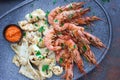 Plate with seafood, King prawns and squid, Fish menu in the restaurant, Dark background Royalty Free Stock Photo