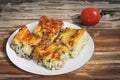 Plateful Of Serbian Traditional Cheese Spinach Pie Zeljanica Slices Set On Old Garden Table Surface With Ripe Tomato Royalty Free Stock Photo