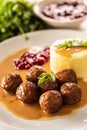 Plate serving Swedish meatballs kottbullar in sauce with mashed potatoes and cranberry sauce Royalty Free Stock Photo