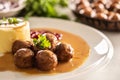 Plate serving Swedish meatballs kottbullar in sauce with mashed potatoes and cranberry sauce Royalty Free Stock Photo
