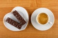 Plate in shape of heart with chocolate wafers, cup with black coffee in saucer on table. Top view Royalty Free Stock Photo
