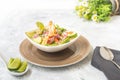 Plate of shrimp ceviche with avocado on a white table