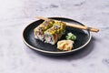 Plate of shrimp and cheese cream uramaki sushi on a marble surface Royalty Free Stock Photo