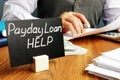 Plate with sign Payday loan help. Royalty Free Stock Photo