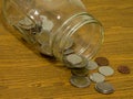 Jar and money coins on wood table