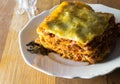 Plate of single serving of spicy beef lasagne for supper on rust