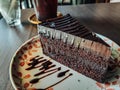 Plate with slice of tasty homemade chocolate cake on table Royalty Free Stock Photo