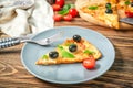 Plate with slice of tasty pizza on wooden table Royalty Free Stock Photo