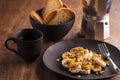 Plate with sliced banana with granola, candied fruit and honey, toast and a cup of coffee Royalty Free Stock Photo