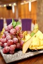 Plate with sliced fruits on servered buffet table at luxury wedding reception indoors, copy space. Royalty Free Stock Photo