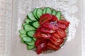 plate with sliced pieces of fresh tomatoes and cucumbers on the table Royalty Free Stock Photo