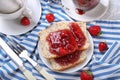 Plate with slices of bread and delicious strawberry jam on napkin Royalty Free Stock Photo