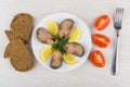 Plate with slices of smoked mackerel, lemon, bread, tomato Royalty Free Stock Photo