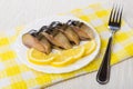 Plate with slices of smoked mackerel, lemon on napkin, fork Royalty Free Stock Photo