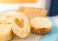 Plate with slices of white baguette bread with slice having hole shaped as heart