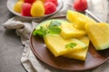 Plate with slices of yellow watermelon on dark table Royalty Free Stock Photo