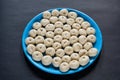 A plate of some small homemade freshly fermented raw bread dough pulp on a black background