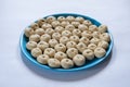 A plate of some small homemade freshly fermented raw bread dough pulp on a white background