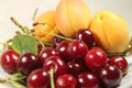 On a plate sour cherry red and apricot Royalty Free Stock Photo