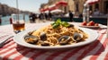 a plate of spaghetti with clams on the table with the background of the canals of Venice and the blurred gondolas